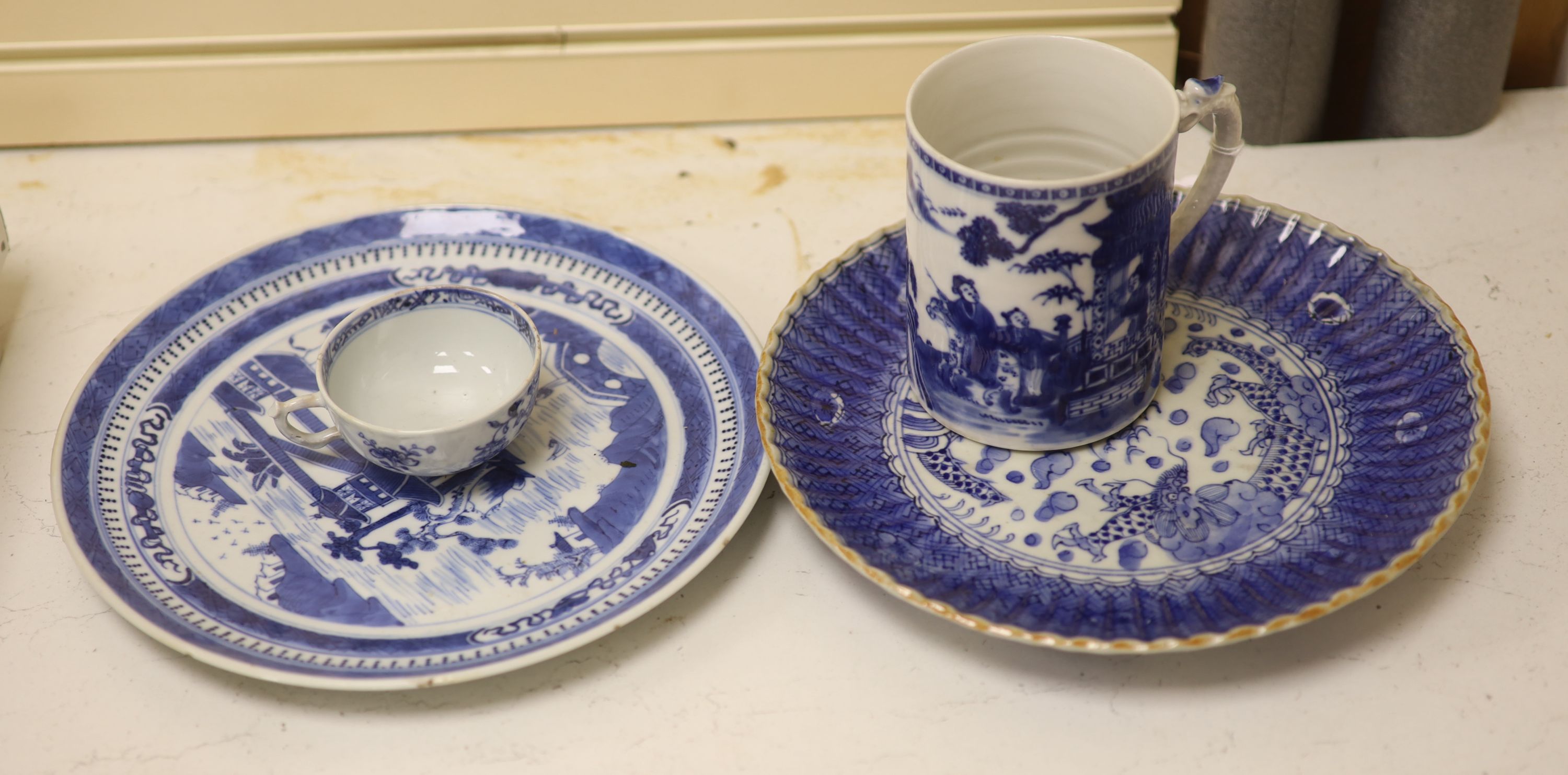 An 18th century Chinese blue and white mug and cup, a 19th century Chinese blue and white plate and a Japanese plate